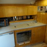 Fairline Targa 30/33 - Galley comprising gas hob, oven, microwave, fridge and sink unit.