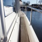Aquador 32 - Teak side decks with sturdy guard rails and side chain gate