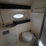 Rinker Fiesta V270 - Heads with toilet, wash hand basin and shower.