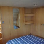 Haines 350 - Long mirror and bookshelves in master cabin