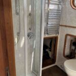 Shower cubicle and heated towel rail
